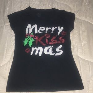 A black shirt that says merry kiss mas